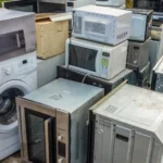 Old washers, microwaves, ovens, and household appliances ready for removal
